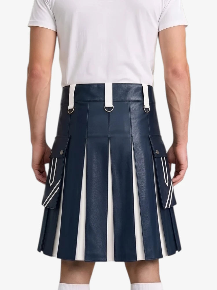 A man wearing a navy blue faux-leather pleated kilt with white vertical stripe details and white suspenders, paired with a white t-shirt, shown from the back against a light gray background.