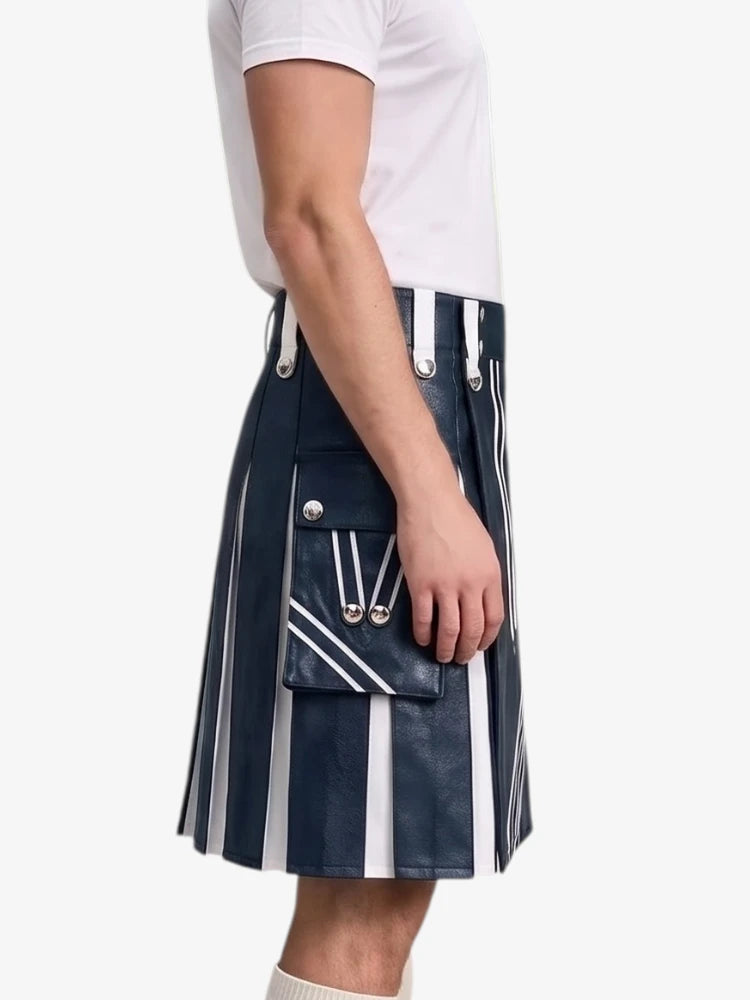 A model wearing a navy blue leather pleated kilt with white vertical stripes and silver-tone hardware, paired with a white t-shirt against a light gray background.