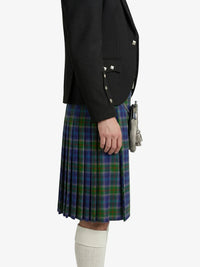 Person wearing a black blazer and a green plaid kilt on a white background