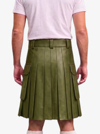 An olive green faux leather pleated kilt with side cargo pockets, shown on a model from the back wearing a light pink t-shirt against a white background.