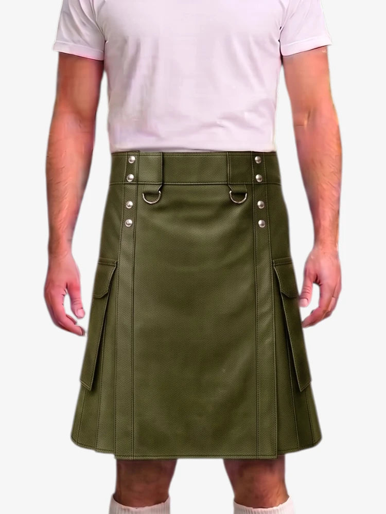 A man wearing an olive green faux-leather kilt with silver-tone metal hardware and side cargo pockets, paired with a light pink t-shirt and white socks, against a plain white background.