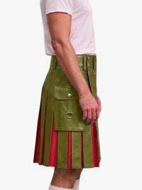A side view of a person wearing a green faux-leather kilt with pleated red fabric underneath, paired with a white t-shirt, against a plain light gray background.