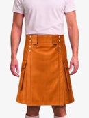A person wearing a tan-brown leather kilt with silver-tone metal hardware and side cargo pockets, paired with a light pink t-shirt and white socks, shown against a plain light gray background.