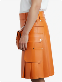 Orange leather skirt worn by a person on a white background