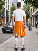 A man stands on a city sidewalk facing away from the camera, wearing a bright orange pleated kilt with white vertical stripes, a white t-shirt, white knee-high socks, and black shoes. Buildings, trees, a black Mercedes, and a bicycle are visible in the urban street setting.
