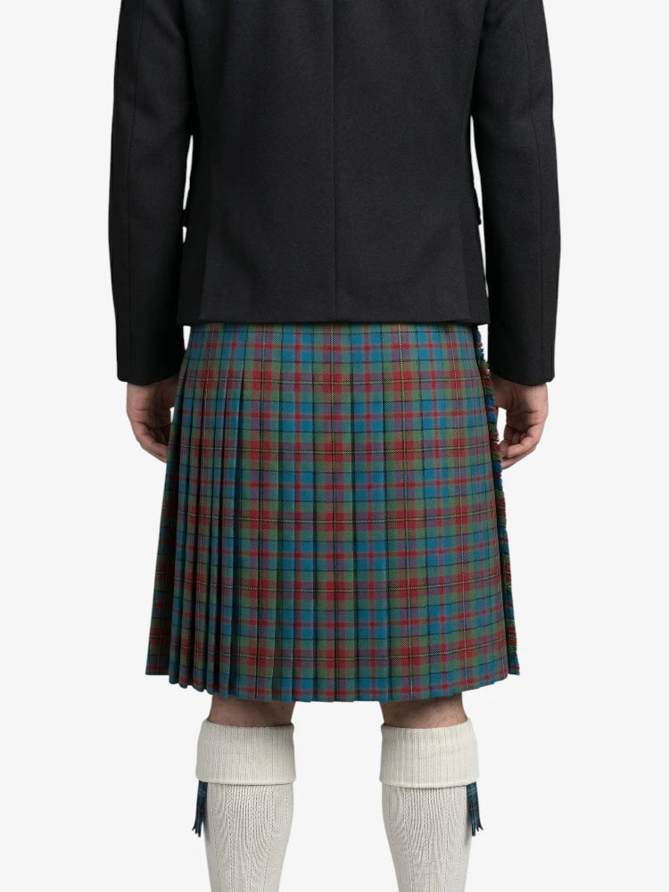 Person wearing a black jacket and a plaid kilt on a white background