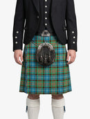 Person wearing a traditional Scottish kilt with a tartan pattern on a white background