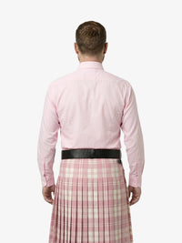 Man wearing a pink shirt and plaid skirt on a white background