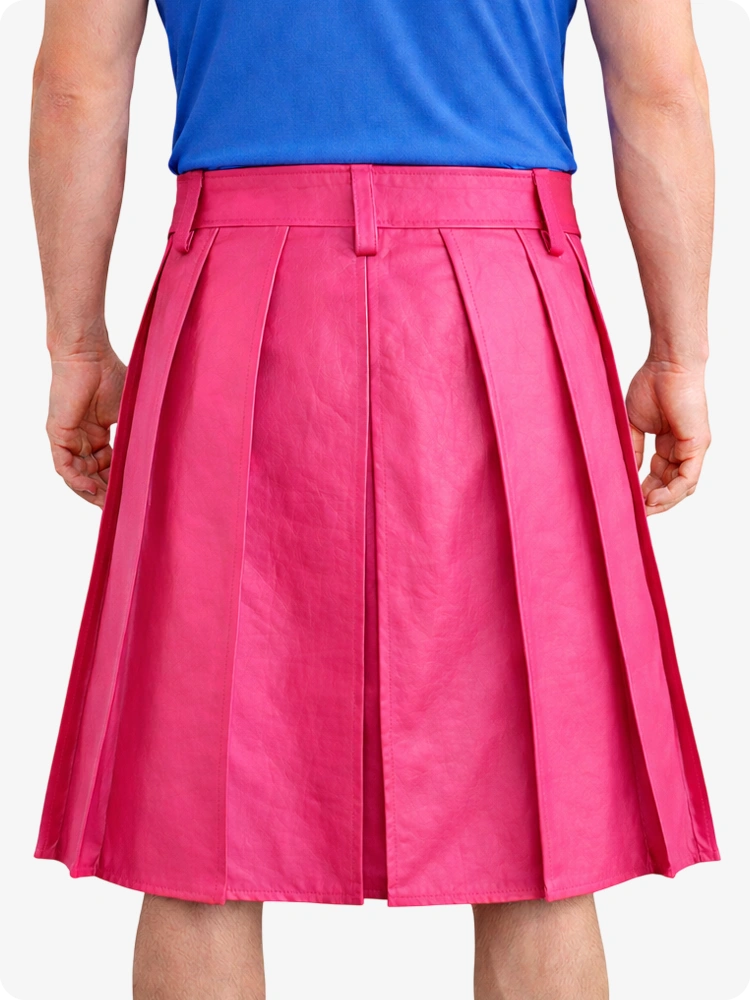 Person wearing a blue top and pink pleated skirt on a white background