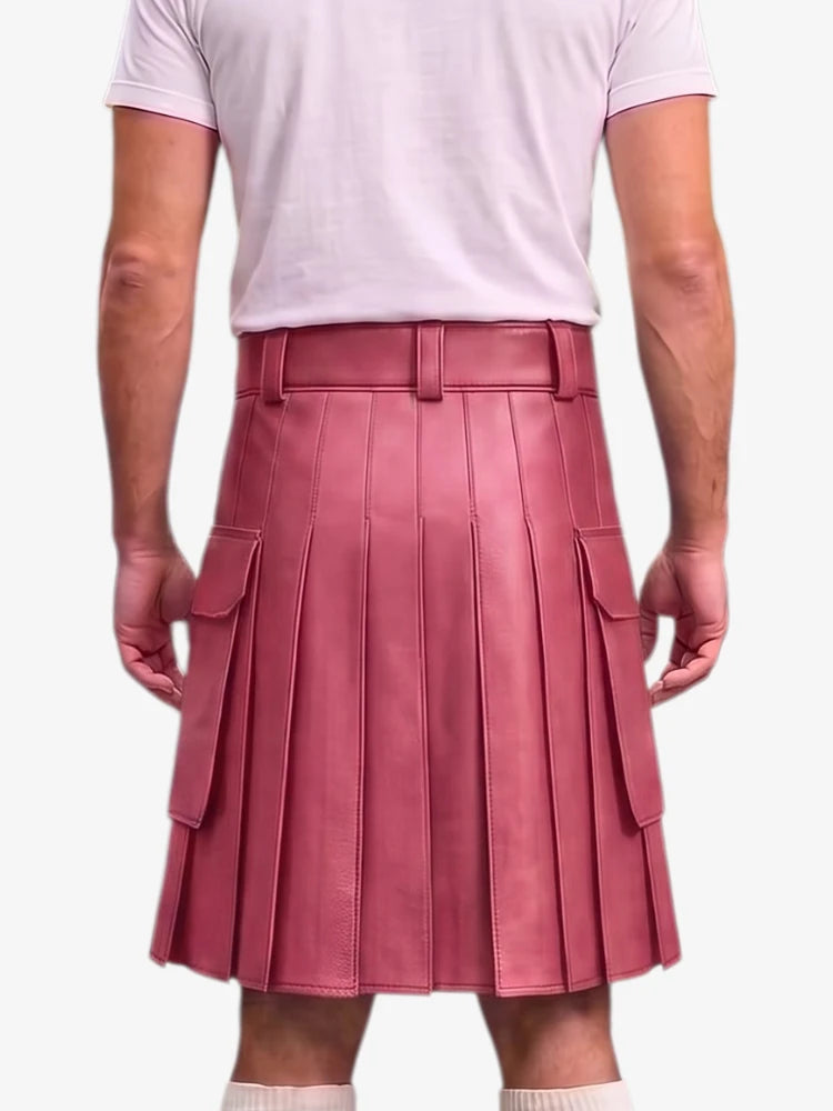 A person shown from the back wearing a dusty rose pink pleated faux leather kilt with side cargo pockets, paired with a light pink t-shirt and white socks, against a light gray background.