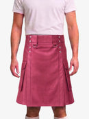 A person wearing a dusty rose pink faux-leather kilt with silver-tone metal hardware, shown from the chest down against a light gray background.