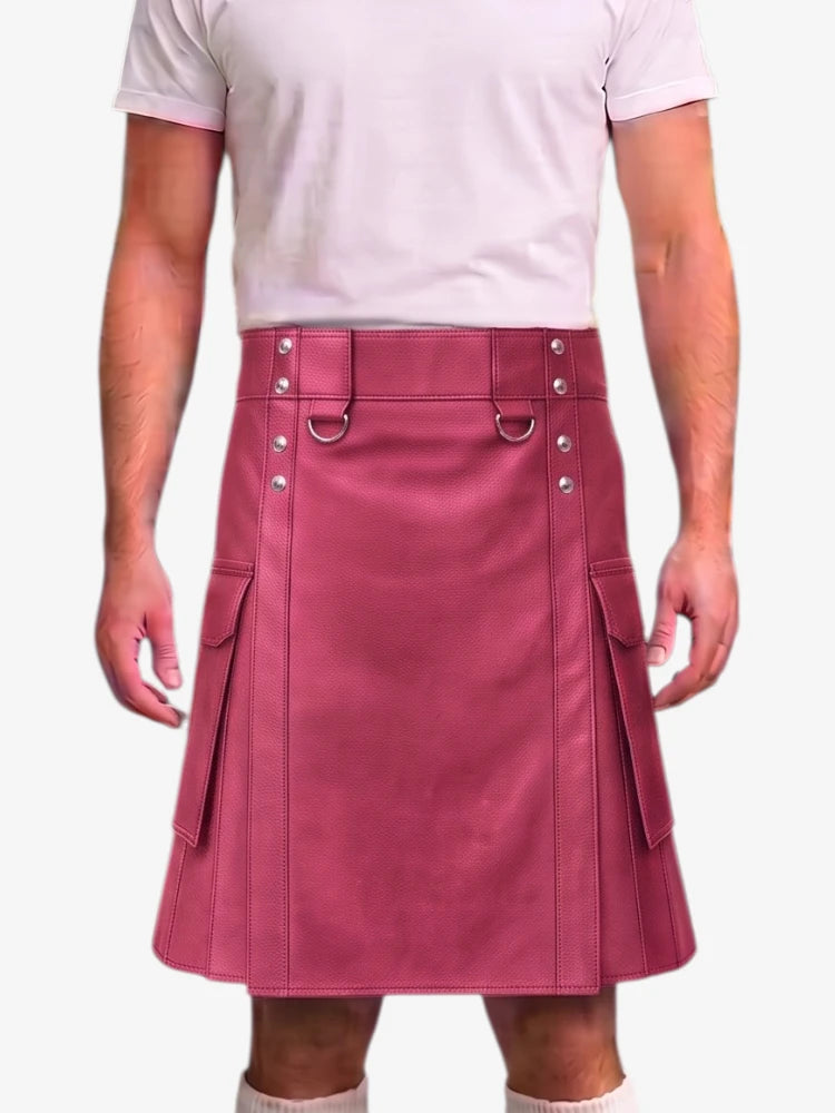 A person wearing a dusty rose pink faux-leather kilt with silver-tone metal hardware, shown from the chest down against a light gray background.