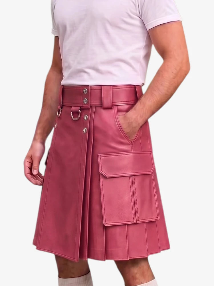 A model wearing a pink faux-leather kilt with a matching belt, silver-tone hardware, and large cargo pockets, paired with a light pink t-shirt.