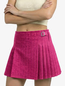 Person wearing a pink pleated skirt with a buckle on a white background