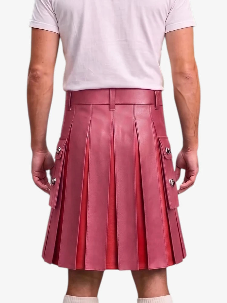 A person shown from the back wearing a pleated leather kilt in a dusty rose pink color, paired with a light pink t-shirt and white socks, against a plain light gray background.