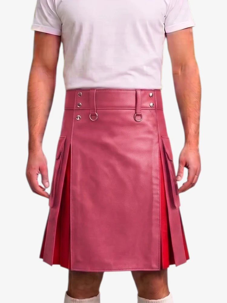 A model wearing a pink faux-leather kilt with pleated side panels, belt loops, and silver-tone hardware, paired with a white t-shirt against a light gray background.