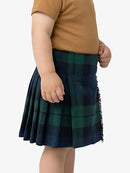 Child wearing a green plaid skirt on a white background