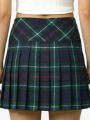 Green plaid skirt worn by a person on a white background