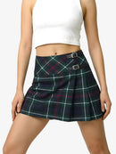 Person wearing a plaid skirt with a white top on a plain background