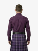 Man wearing a purple shirt and plaid kilt on a white background