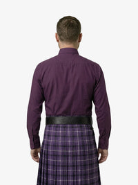 Man wearing a purple shirt and plaid kilt on a white background