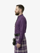 Man wearing a purple shirt and plaid pants on a white background