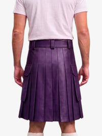 A person shown from the back wearing a purple pleated leather kilt with side cargo pockets, paired with a light pink t-shirt and white socks, against a plain light gray background.