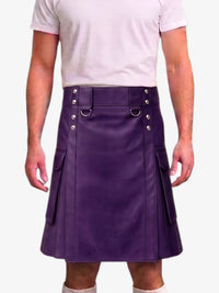 A man wearing a purple faux-leather kilt with silver-tone hardware and side pockets, paired with a light pink t-shirt, shown from the chest down against a white background.