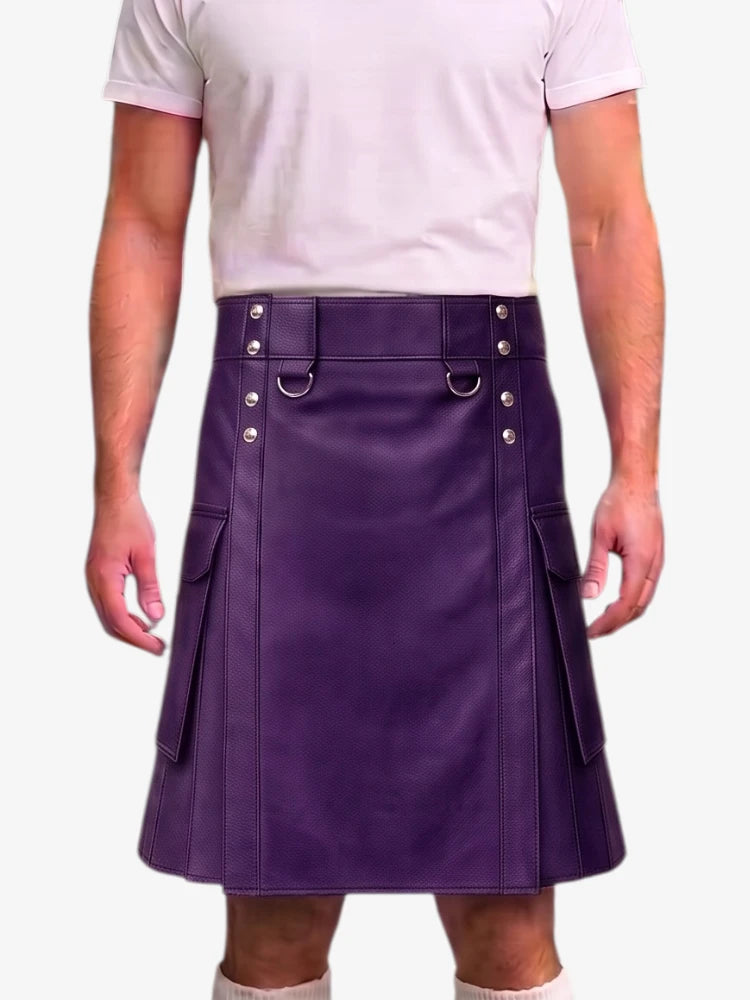 A man wearing a purple faux-leather kilt with silver-tone hardware and side pockets, paired with a light pink t-shirt, shown from the chest down against a white background.