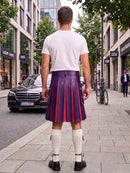 A man standing on a city sidewalk, viewed from behind, wearing a white t-shirt, a purple pleated leather kilt with red stripes, white knee-high socks, and black shoes. Buildings, trees, a parked black Mercedes, and a bicycle are visible in the background.