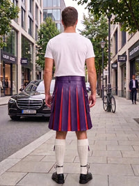 A man standing on a city sidewalk, viewed from behind, wearing a white t-shirt, a purple pleated leather kilt with red stripes, white knee-high socks, and black shoes. Buildings, trees, a parked black Mercedes, and a bicycle are visible in the background.