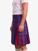 A man wearing a purple faux-leather kilt with red pleated lining and silver hardware, paired with a white t-shirt and white socks, shown from the chest down against a light gray background.