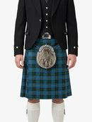 Person wearing a traditional Scottish kilt with a tartan pattern on a white background