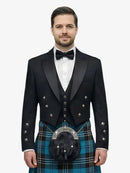 Man wearing a black prince charlie jacket with a ramsay blue tartan plaid kilt on a white background