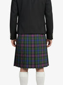 Person wearing a black jacket and plaid kilt on a white background