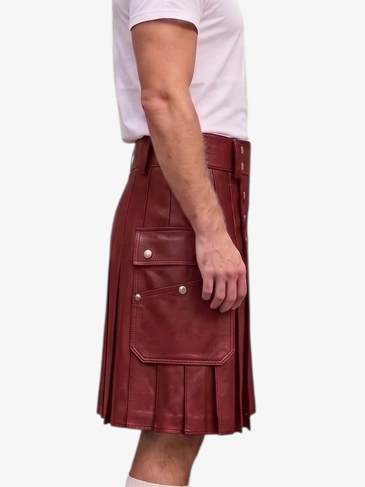 A side view of a person wearing a dark red leather kilt with pleated detailing and flap pockets with silver-tone snaps, paired with a white t-shirt, against a plain white background.