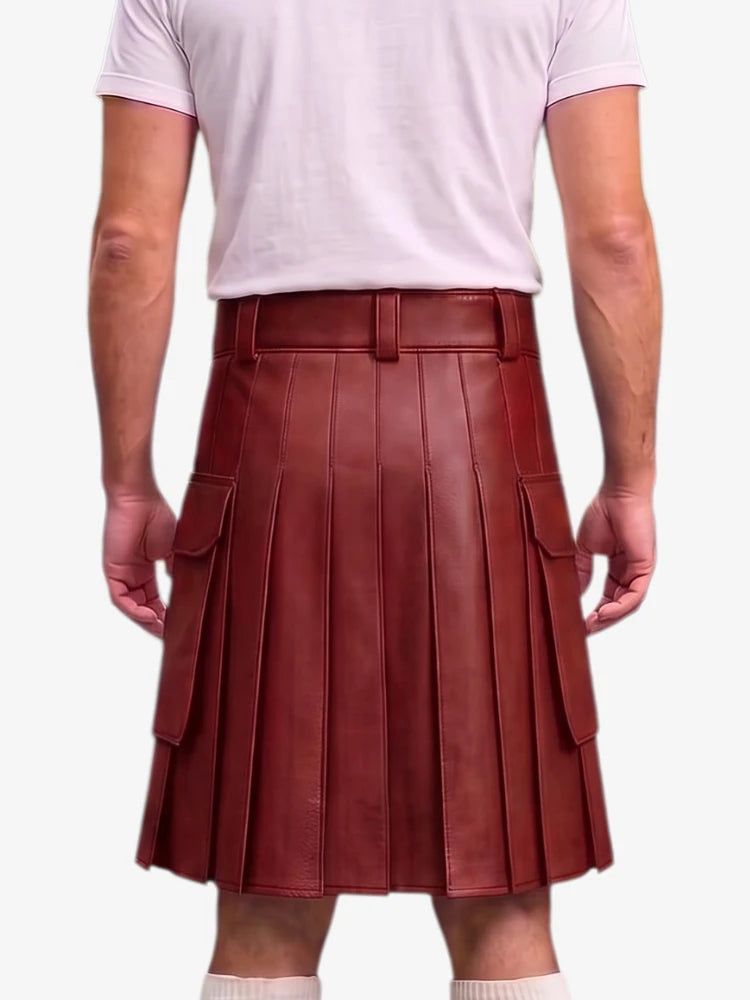 A person shown from the back wearing a dark reddish-brown pleated leather kilt with side cargo pockets, paired with a light pink t-shirt and white socks, against a plain light gray background.