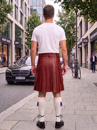 A man viewed from behind wearing a white t-shirt and a reddish-brown pleated leather kilt, standing on a city sidewalk with a Mercedes-Benz car and storefronts in the background.