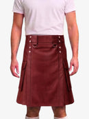 A person wearing a burgundy faux-leather kilt with silver-tone metal hardware, a matching belt, and side flap pockets, paired with a light pink t-shirt against a plain white background.