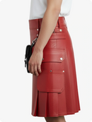 Red leather skirt worn by a person on a white background