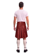 A man shown from the back wearing a dark red leather kilt, a light pink t-shirt, white knee-high socks, and black shoes, isolated on a white background.