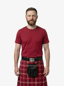 Man wearing a red t-shirt and red plaid kilt on a white background