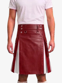 A person wearing a burgundy faux-leather kilt with white side panels and silver-tone hardware, paired with a light pink t-shirt against a plain white background.