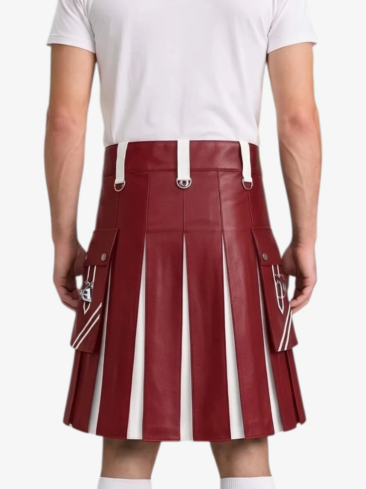 A person shown from the back wearing a pleated red leather kilt with white vertical stripe panels and white belt loops, paired with a white t-shirt and white socks, against a light gray studio background.