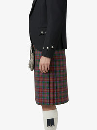Person wearing a black blazer and red plaid kilt on a white background