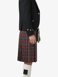 Person wearing a black jacket and plaid kilt on a white background