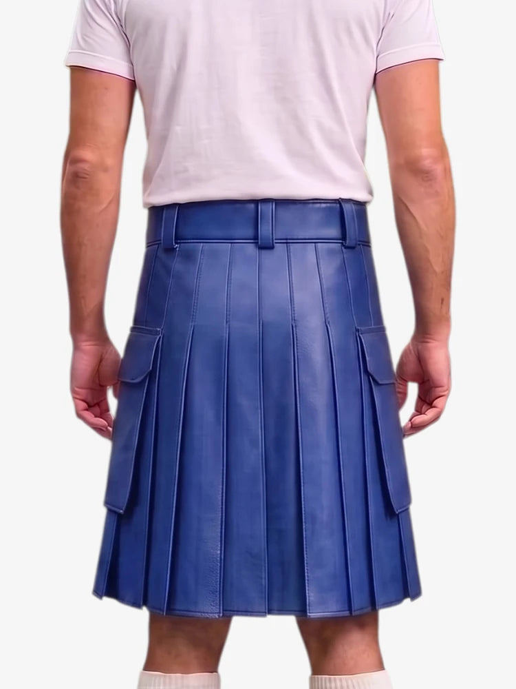 A person shown from the back wearing a blue pleated leather kilt with side flap pockets, paired with a light pink t-shirt and white socks, against a plain light gray background.
