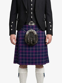 Person wearing a traditional Scottish kilt with a sporran on a white background