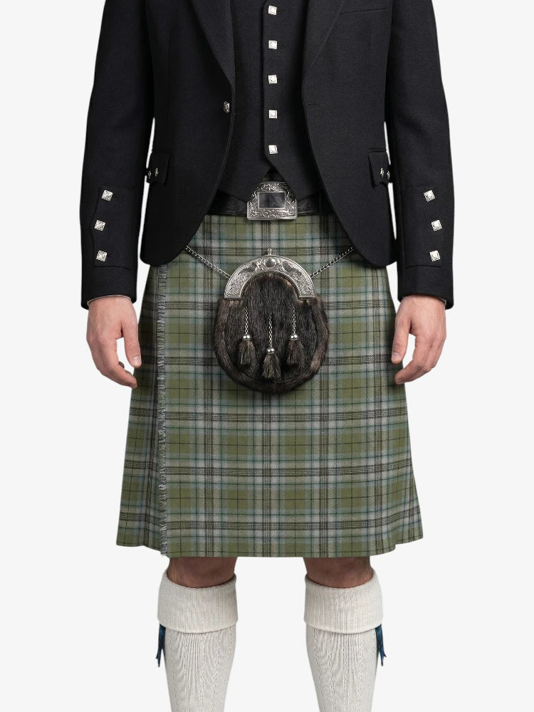 Person wearing a traditional Scottish kilt with a sporran on a white background