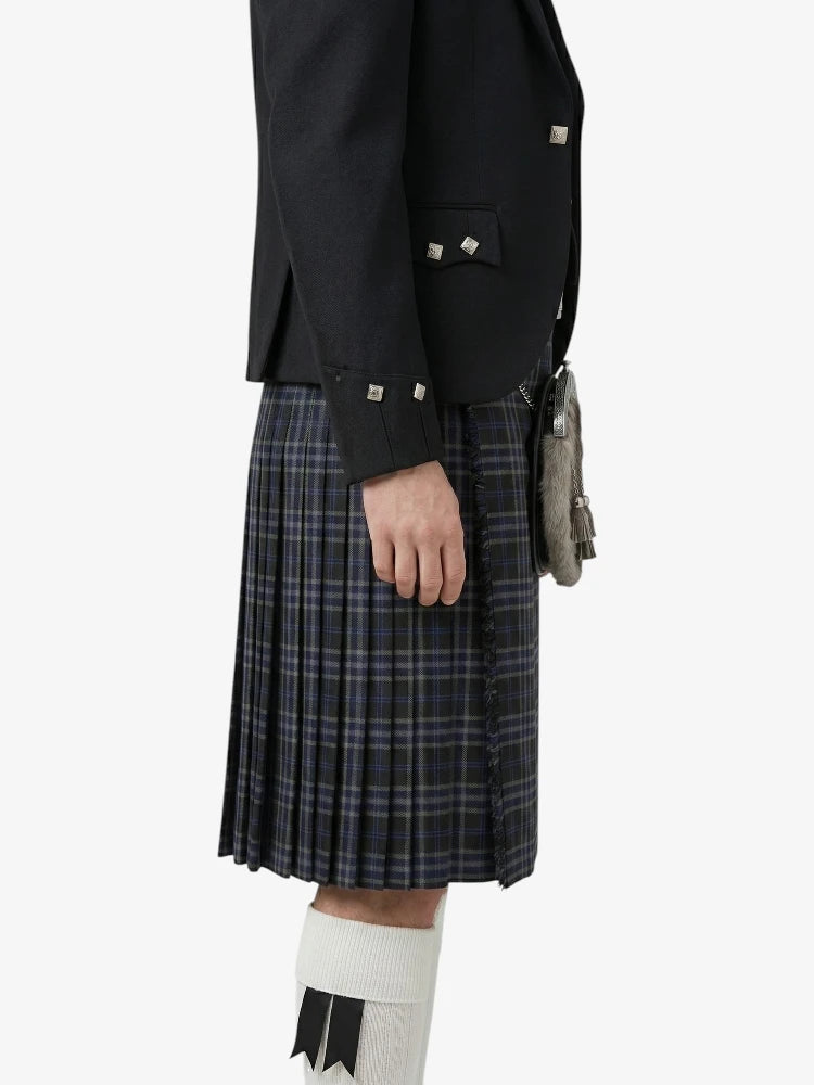 Person wearing a dark jacket and plaid kilt on a white background